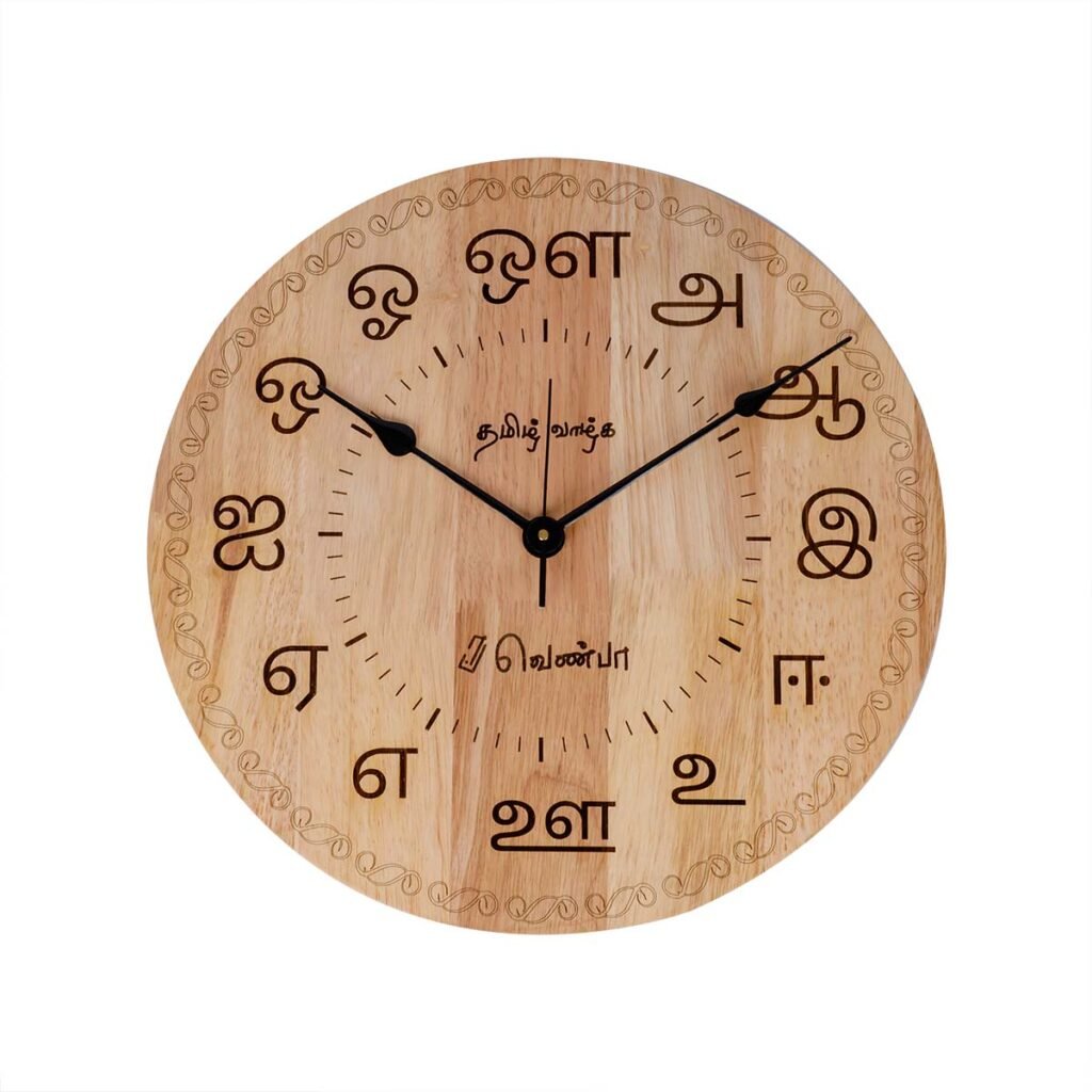 Front-facing product shot of VENBAA 15-inch round wooden wall clock featuring engraved Tamil vowel script characters on a clean white background.